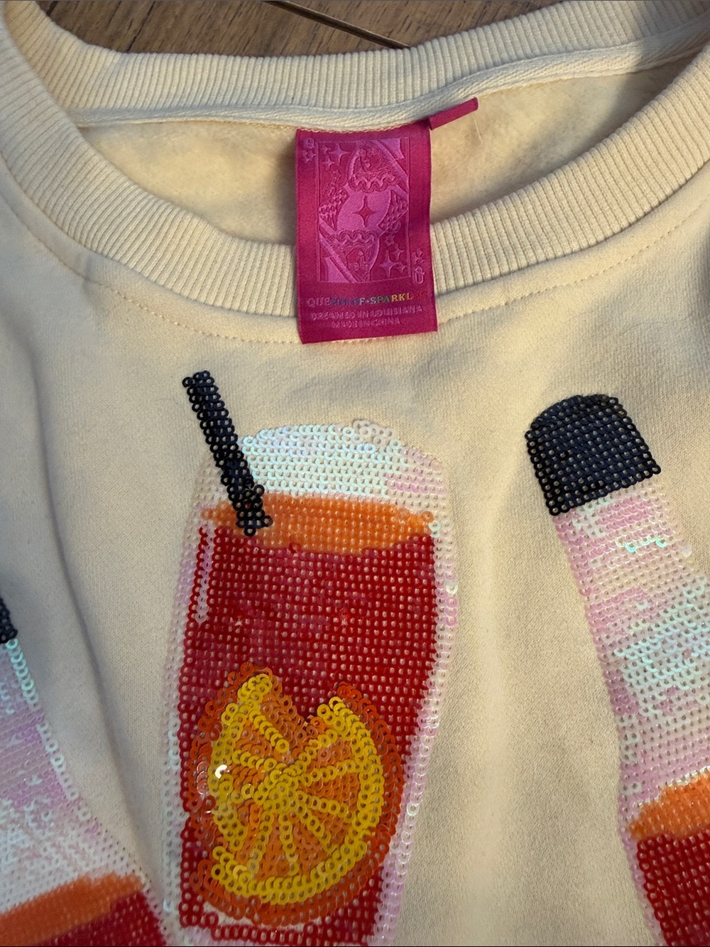 QUEEN OF SPARKLES Cream Sweater with Red & Orange Spritz Bottle Motif - Picture 3 of 4
